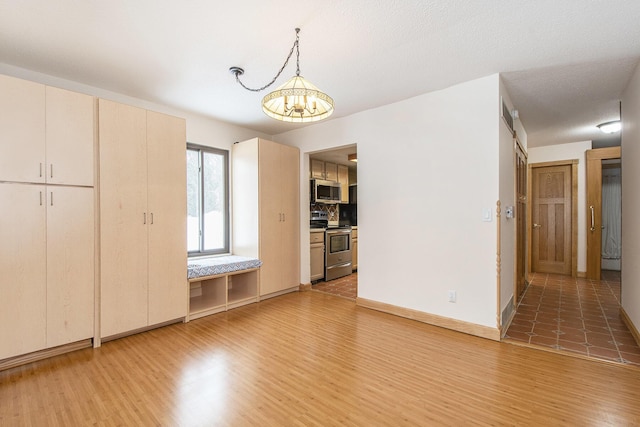 interior space featuring a textured ceiling, hardwood / wood-style floors, and a chandelier