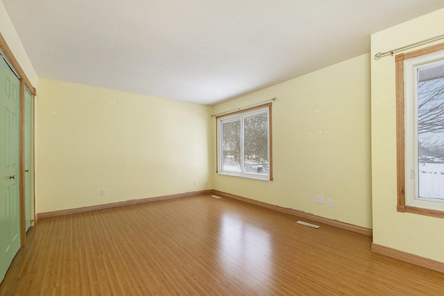 spare room with light wood-type flooring