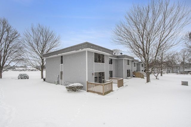 view of snow covered rear of property