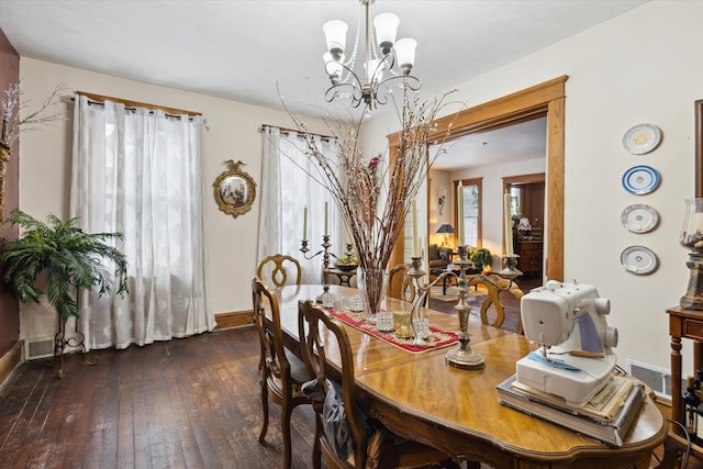 dining room featuring a chandelier and dark hardwood / wood-style floors