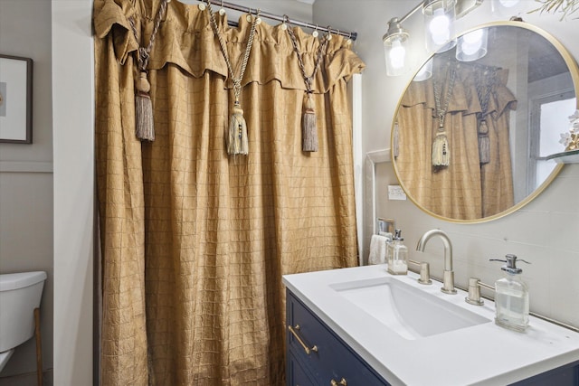 bathroom featuring decorative backsplash, toilet, and vanity