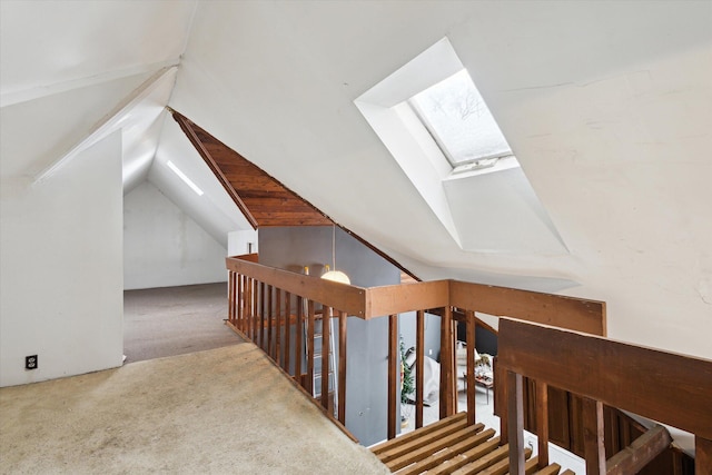 interior space with carpet and lofted ceiling with skylight