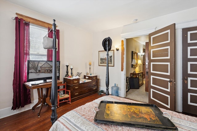 bedroom with dark wood-type flooring