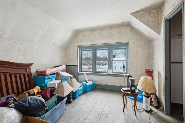 additional living space featuring lofted ceiling and hardwood / wood-style floors