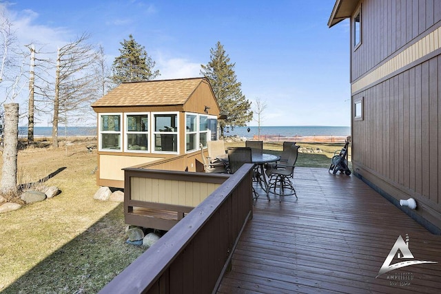 wooden deck with a water view and a sunroom