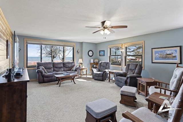 carpeted living room featuring ceiling fan