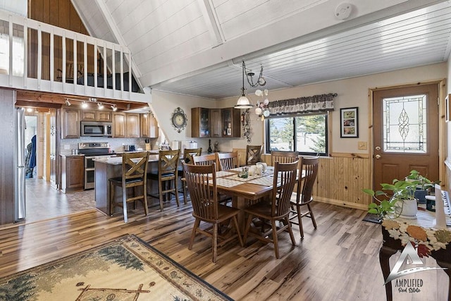 dining room with high vaulted ceiling, dark hardwood / wood-style floors, wood ceiling, and an inviting chandelier