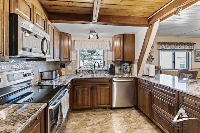 kitchen with beam ceiling, sink, light stone countertops, appliances with stainless steel finishes, and wooden ceiling