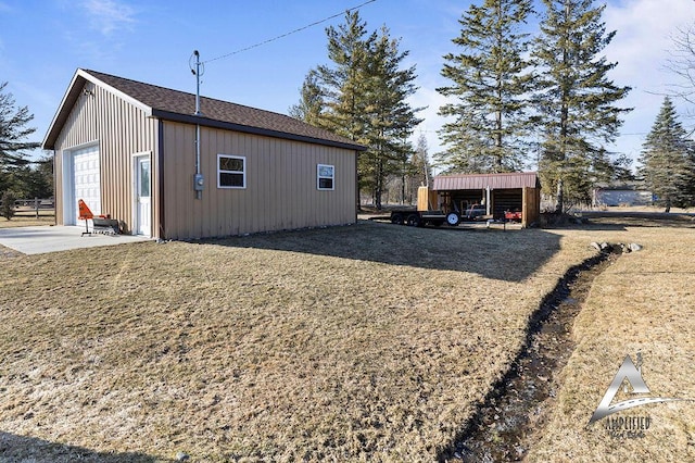 view of side of property featuring a carport, an outdoor structure, and a garage