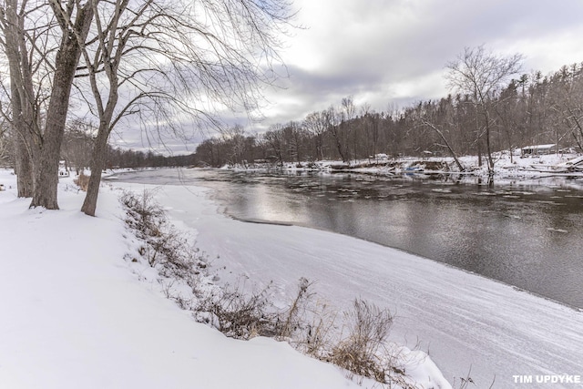 snowy yard with a water view