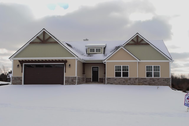 craftsman-style home with stone siding and an attached garage