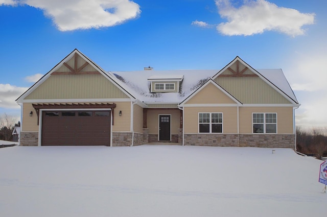 craftsman-style house featuring a garage and stone siding