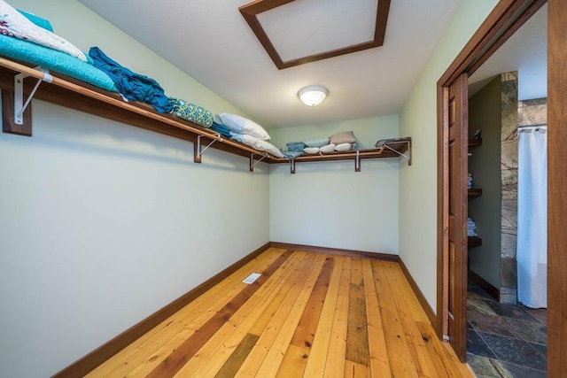 walk in closet featuring light hardwood / wood-style flooring