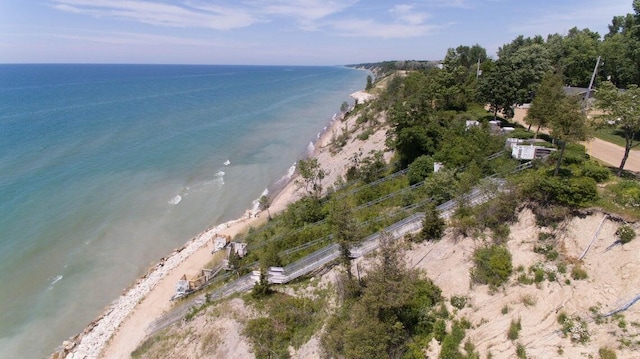 drone / aerial view featuring a beach view and a water view