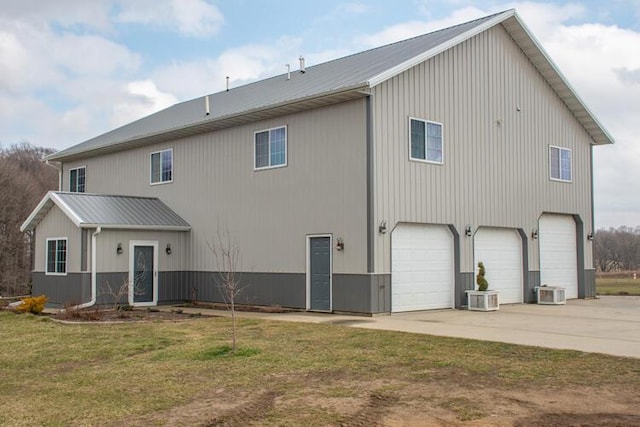 rear view of property featuring a garage and a yard