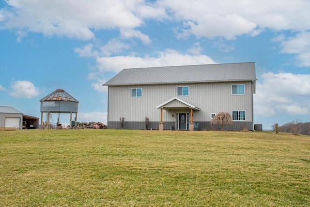 rear view of property with a gazebo and a yard