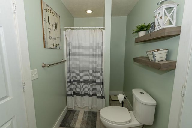 bathroom with curtained shower and toilet