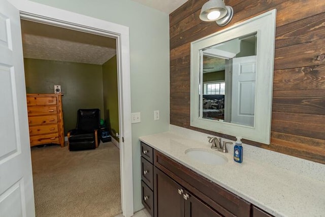 bathroom with wooden walls and vanity