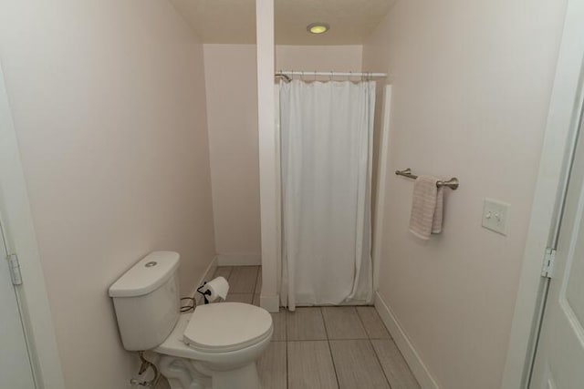 bathroom featuring toilet and a shower with shower curtain