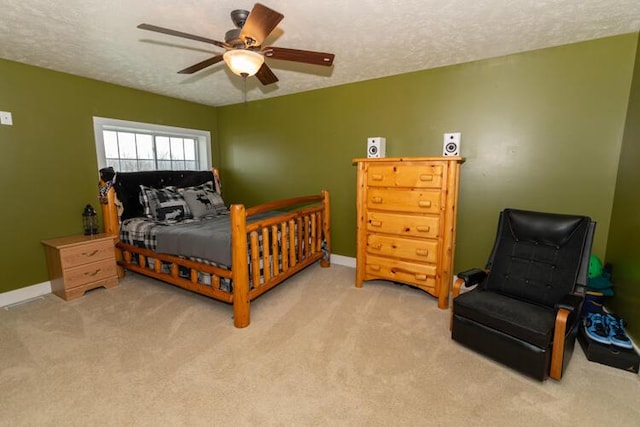 carpeted bedroom with a textured ceiling and ceiling fan