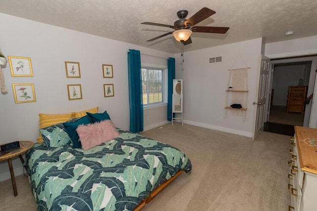 bedroom with a textured ceiling, ceiling fan, and light carpet