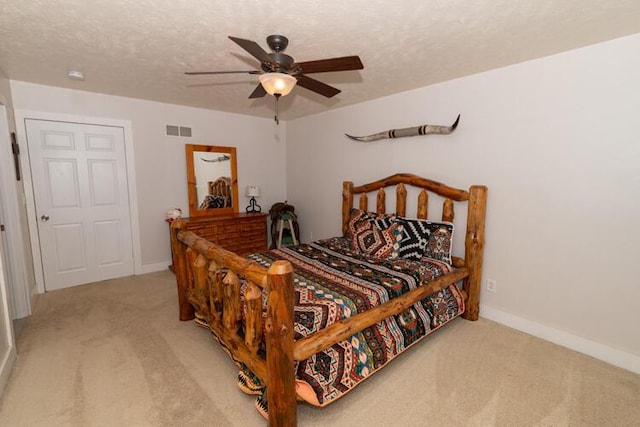 carpeted bedroom with a textured ceiling and ceiling fan