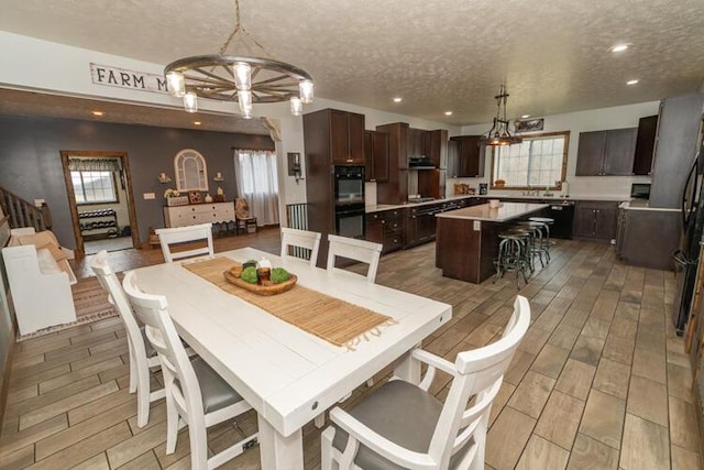 dining space featuring a textured ceiling and a notable chandelier