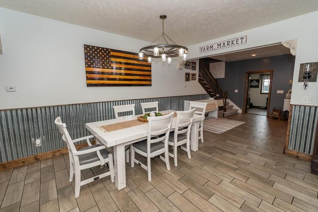 dining area featuring a textured ceiling and an inviting chandelier