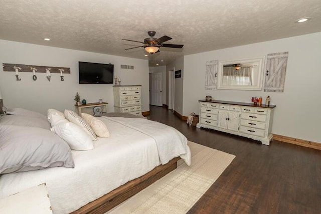 bedroom with a textured ceiling, ceiling fan, and dark wood-type flooring