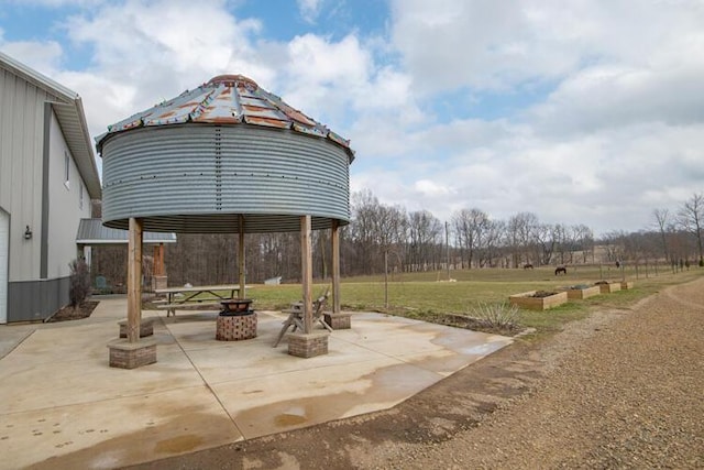 view of patio featuring a gazebo and a fire pit