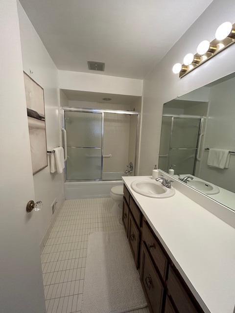 full bathroom with toilet, combined bath / shower with glass door, and vanity