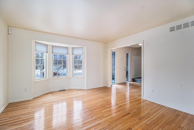 unfurnished room with light hardwood / wood-style flooring