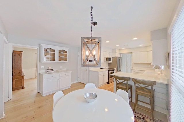 dining room with sink and light wood-type flooring