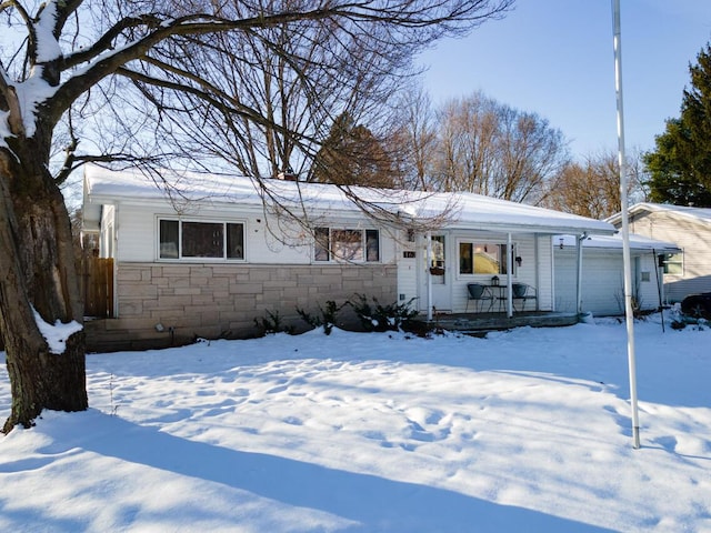 single story home with covered porch and a garage