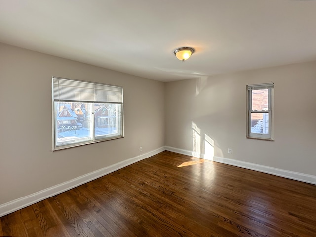 spare room featuring dark wood-type flooring