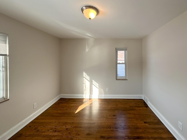 empty room featuring dark hardwood / wood-style flooring