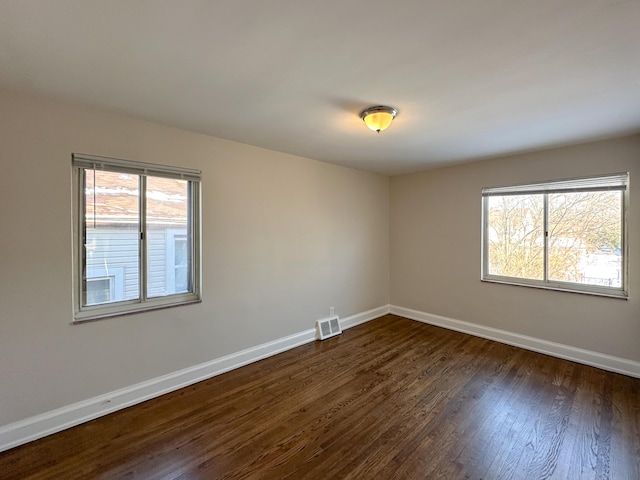 empty room with dark wood-type flooring