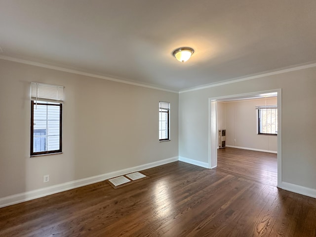 unfurnished room with dark hardwood / wood-style flooring, a wealth of natural light, and ornamental molding