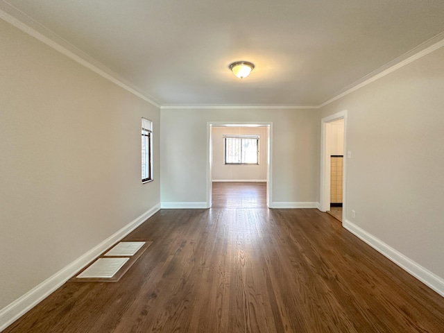 unfurnished room with ornamental molding and dark hardwood / wood-style floors