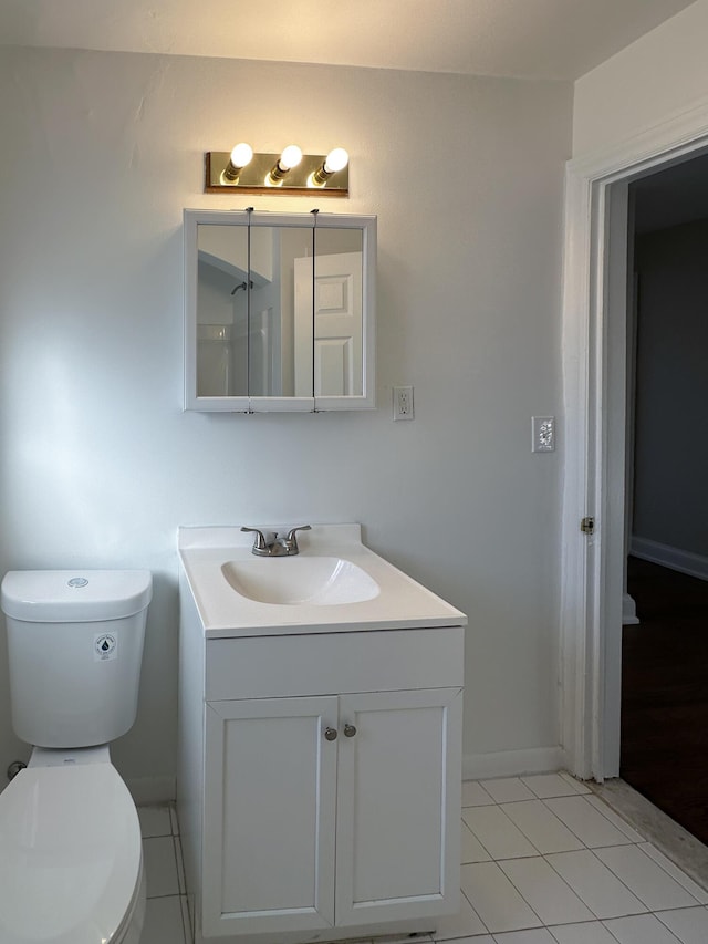 bathroom featuring tile patterned floors, toilet, and vanity