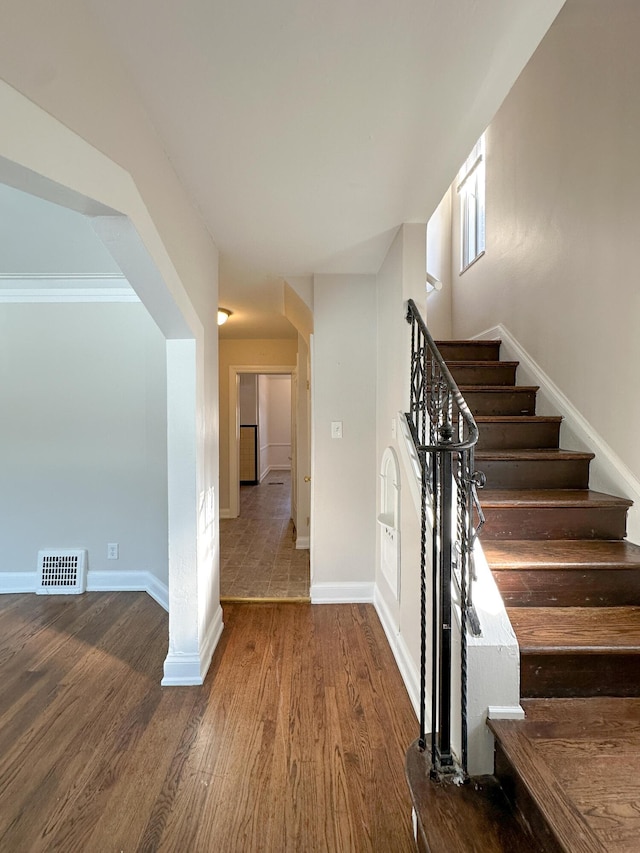 staircase with wood-type flooring