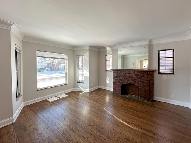 unfurnished living room featuring dark wood-type flooring, a fireplace, a wealth of natural light, and ornamental molding