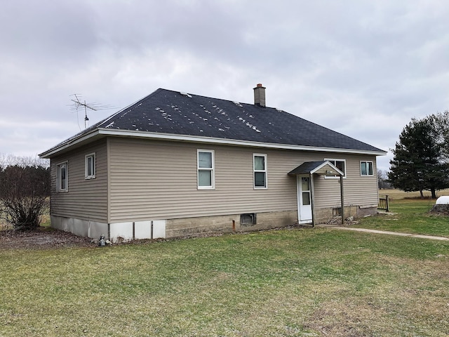 rear view of house featuring a yard