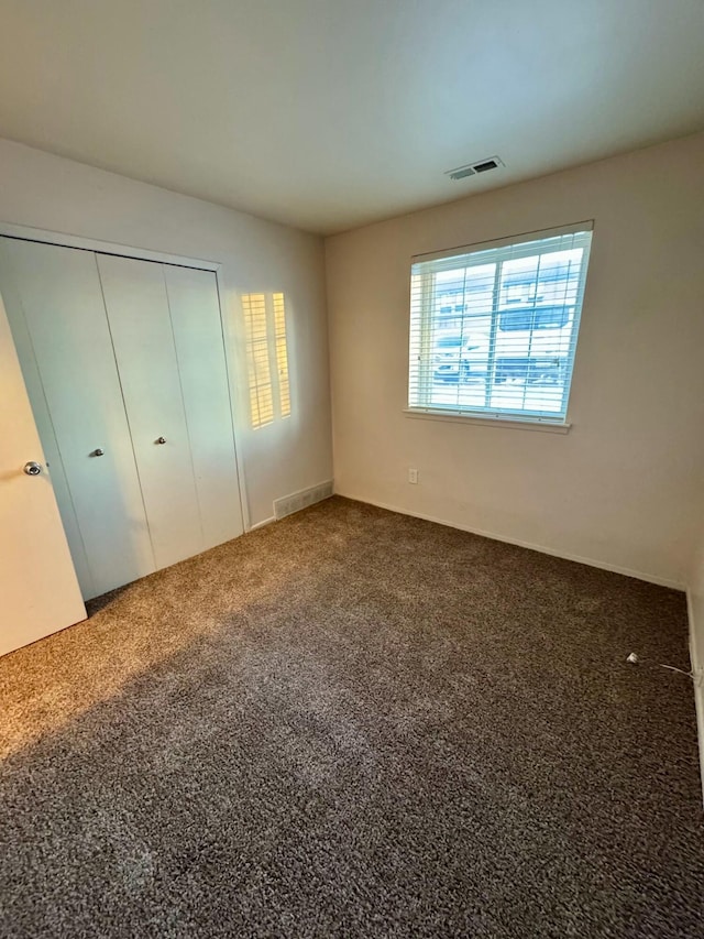 unfurnished bedroom featuring a closet and carpet