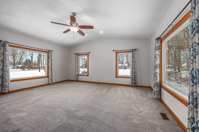 empty room featuring ceiling fan, carpet flooring, and lofted ceiling