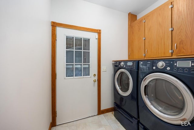 laundry room featuring independent washer and dryer and cabinets