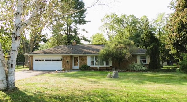 single story home featuring a garage and a front lawn