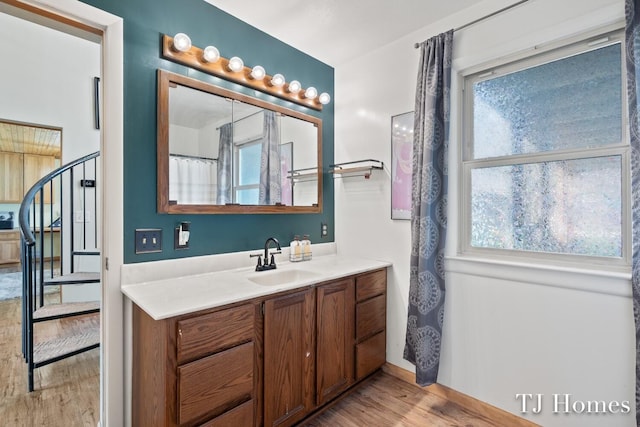 bathroom with vanity and hardwood / wood-style flooring