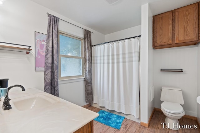 bathroom with vanity, hardwood / wood-style floors, and toilet