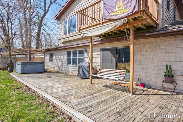 wooden deck with grilling area and a hot tub